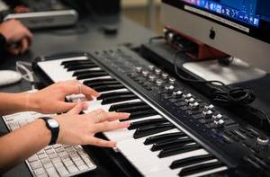 A student plays a keyboard