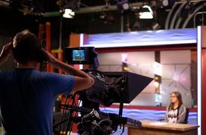 A student giving a news report in a studio